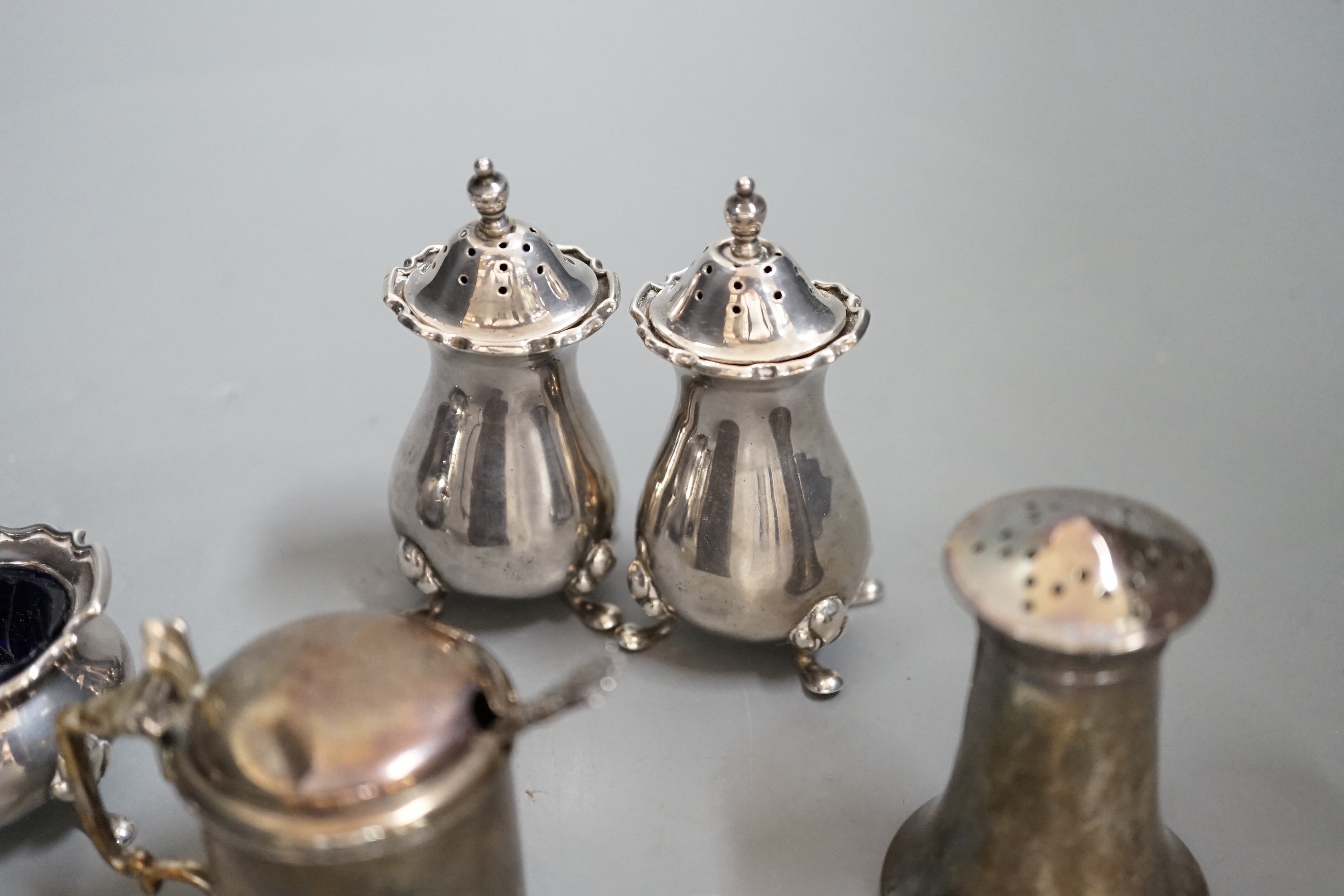 A George V silver four piece condiment set, Birmingham, 1922 and three other silver condiments.